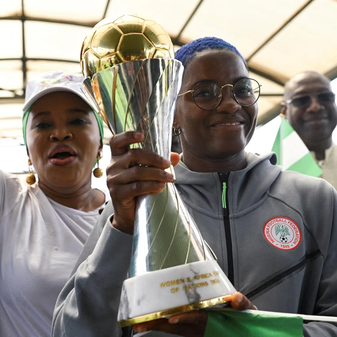 FILE PHOTO: Nigeria’s Super Falcons captain Rasheedat Ajibade holds the Women’s Africa Cup of Nations (WAFCON) trophy as supporters cheers at Nnamdi Azikiwe International Airport in Abuja, following the team’s victory in Morocco, July 28, 2025. REUTERS/Marvellous Durowaiye/File Photo