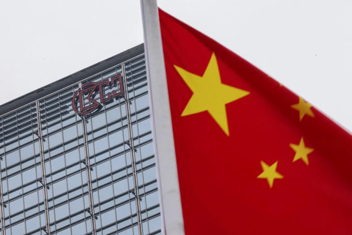 A Chinese national flag flutters in the wind with the Cheung Kong Center building and CK Hutchison logo in the background in Hong Kong, China, April 1, 2025. REUTERS/Tyrone Siu