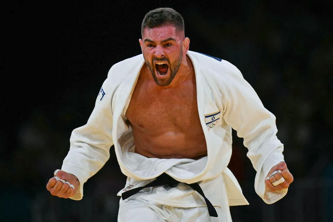 Israel's Peter Paltchik celebrates after beating Netherlands' Michael Korrel in the judo men's -100kg repechage bout of the Paris 2024 Olympic Games.
