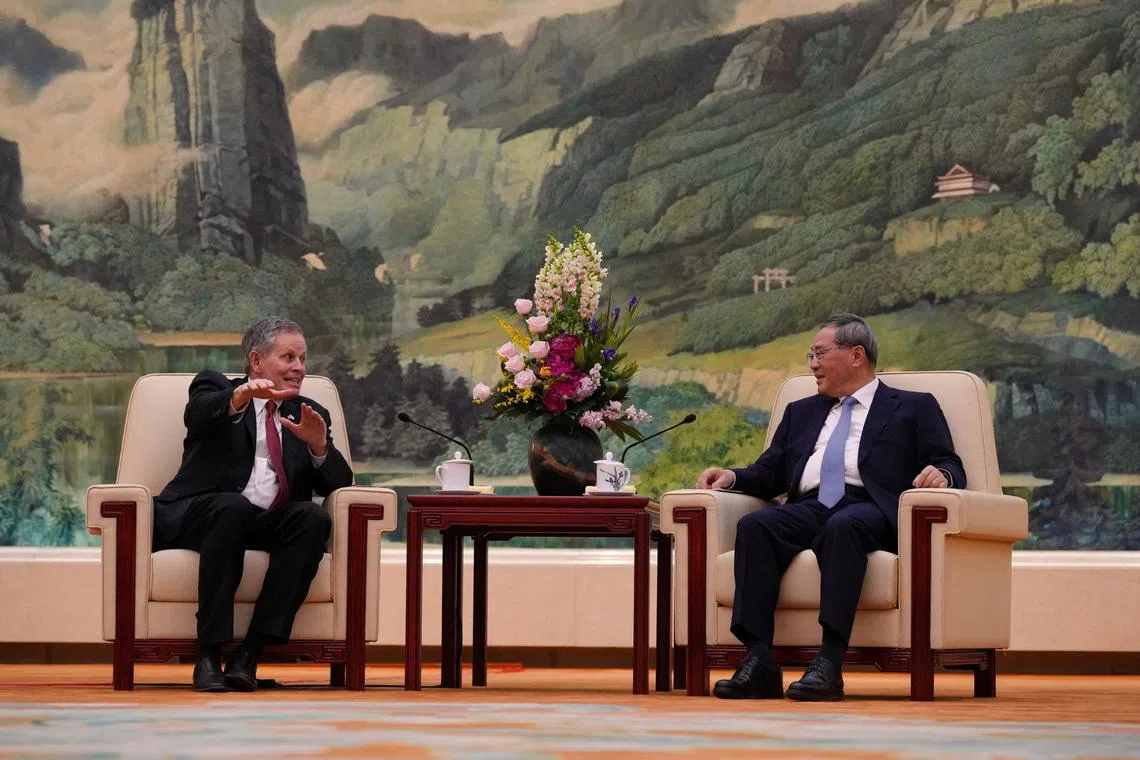 U.S. Senator Steve Daines, left, talks to Chinese Premier Li Qiang during a meeting at the Great Hall of the People, in Beijing, Thursday, May 7, 2026.     Andy Wong/Pool via REUTERS