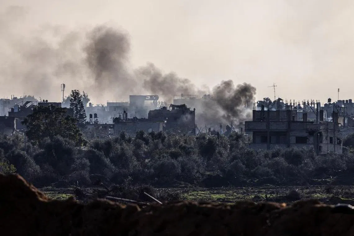 Smoke rises from damaged buildings, amid the ongoing ground operation of the Israeli army against Palestinian Islamist group Hamas, in the Gaza Strip.