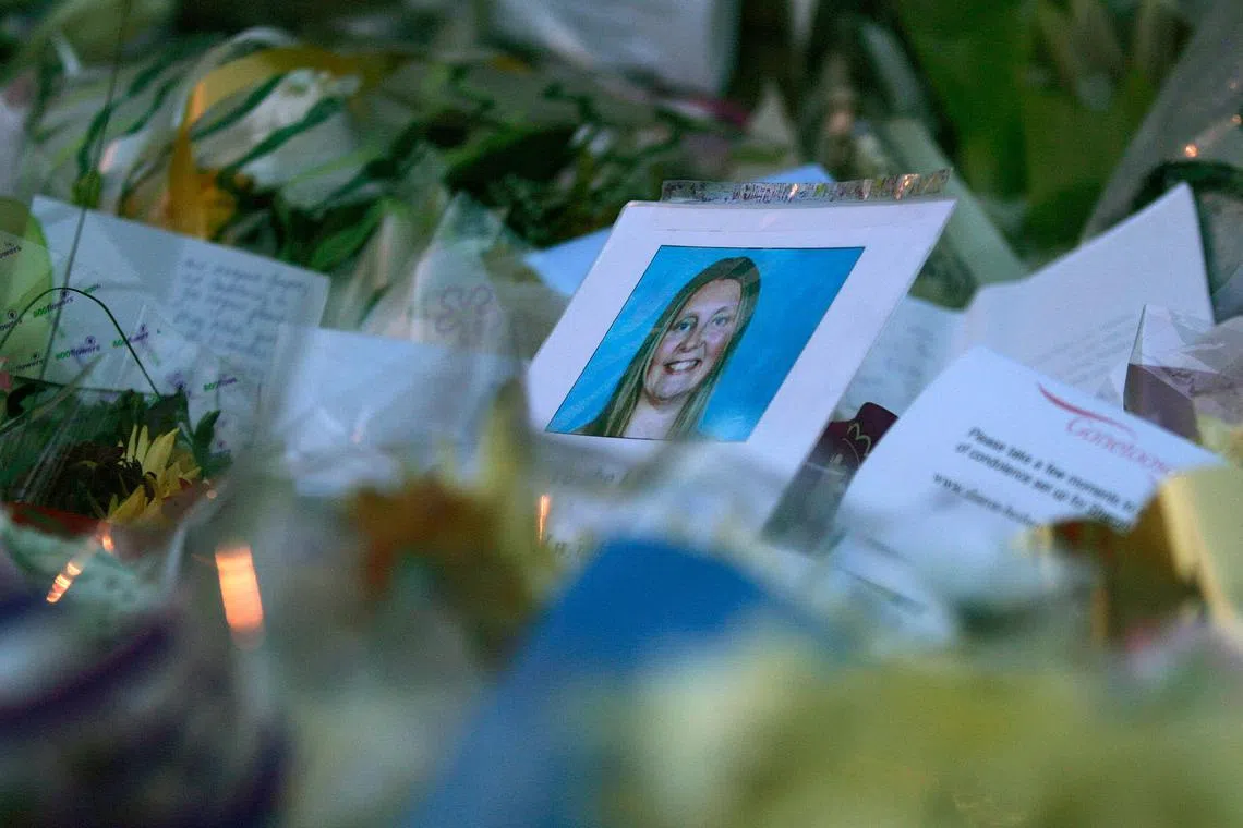 FILE PHOTO: A photograph of murdered Sharon Beshenivsky is seen among the floral tributes left by well-wishers in Bradford November 20, 2005.  REUTERS/Russell Boyce/ File photo