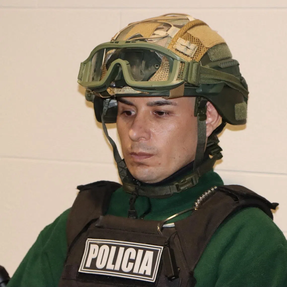 A man identified as Angel Esteban Aguilar, leader of the Ecuadorian criminal group Los Lobos, is photographed after his arrest, who is wanted in connection with the 2023 assassination of Ecuadorean presidential candidate Fernando Villavicencio, at the international airport El Dorado in Bogota, Colombia, March 18, 2026. Colombian Migration/Handout via REUTERS