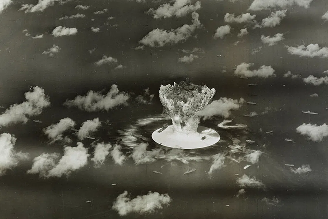 FILE PHOTO: A mushroom cloud rises with ships below during Operation Crossroads nuclear weapons test on Bikini Atoll, Marshall Islands in this 1946 handout provided by the U.S. Library of Congress.  The United States said on April 25, 2014, it was examining lawsuits filed by the Marshall Islands against it and eight other nuclear-armed countries that accuse them of failing in their obligation to negotiate nuclear disarmament.  REUTERS/U.S. Library of Congress/Handout via Reuters/File Photo
