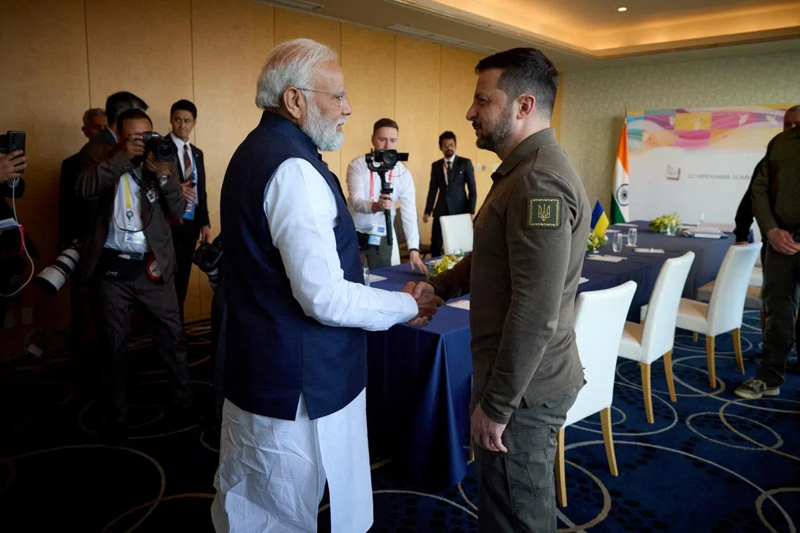 FILE PHOTO: Ukraine's President Volodymyr Zelenskiy and Indian Prime Minister Narendra Modi shake hands during the G7 leaders' summit in Hiroshima, Japan May 20, 2023.  Ukrainian Presidential Press Service/Handout via REUTERS/File Photo