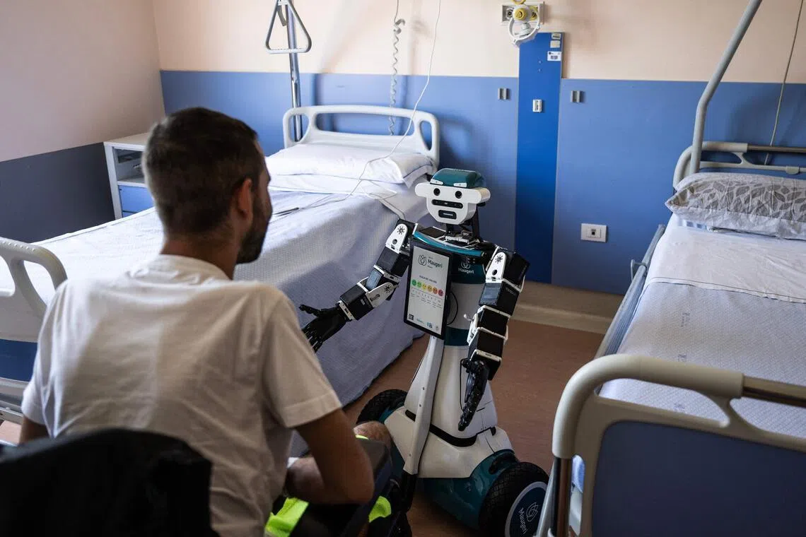 Humanoid robot Alter-Ego assisting a patient at the Maugeri Hospital in Milan on June 12.