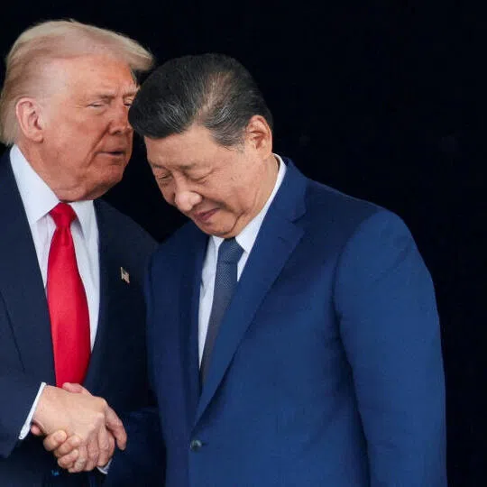 US President Donald Trump and Chinese President Xi Jinping talk as they leave after a bilateral meeting at Gimhae International Airport, South Korea on the sidelines of the Apec summit.