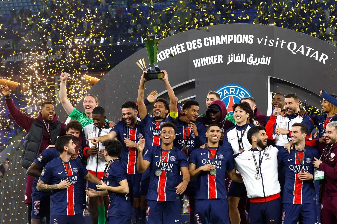 Paris Saint-Germain players celebrate with the trophy after winning the French Champions' Trophy (Trophee des Champions) final football match between Paris Saint-Germain (PSG) and AS Monaco (ASM) at the Stadium 974 in Doha on January 5, 2025. (Photo by KARIM JAAFAR / AFP)