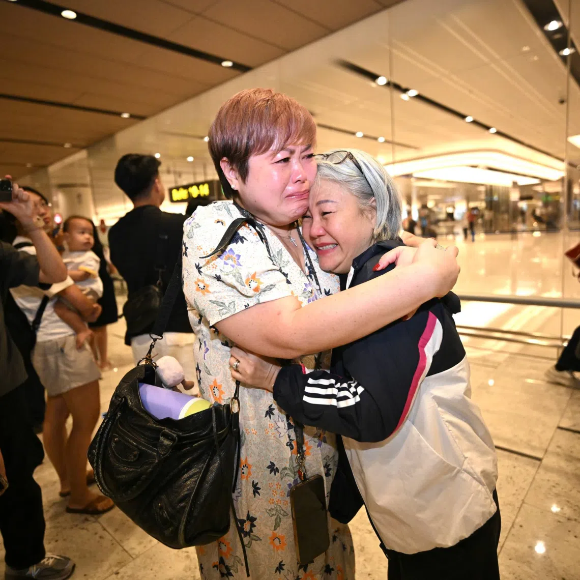 Public relations officer Cynthia Chew hugging her niece Linda Giam at Changi Airport after returning from Dubai on March 5.