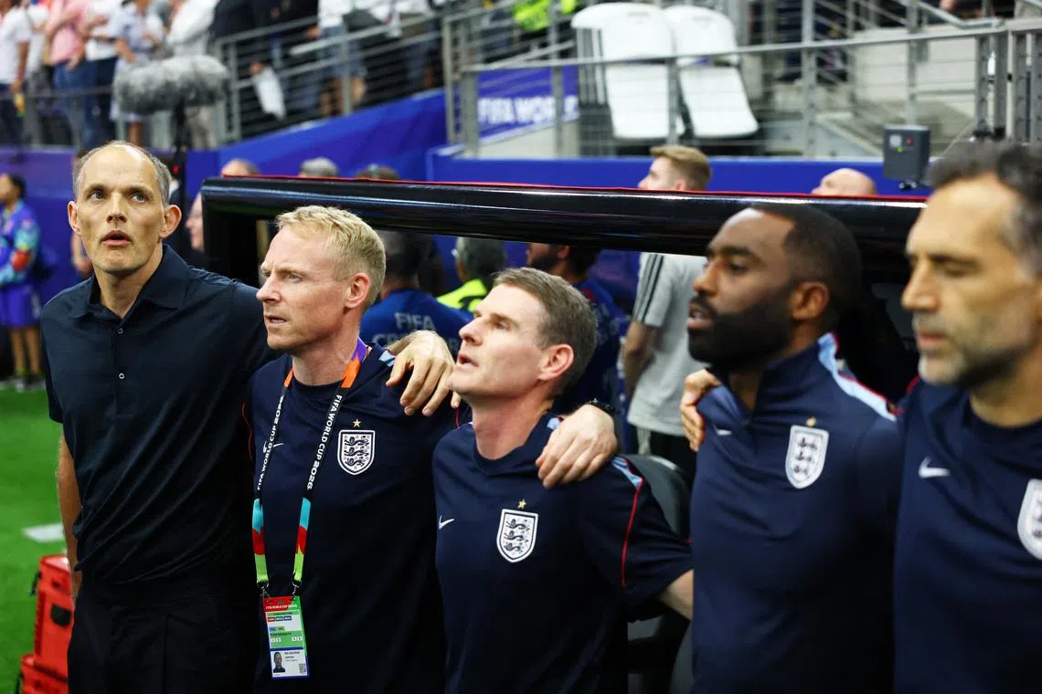 Soccer Football - FIFA World Cup 2026 - Group L - England v Croatia - Dallas Stadium, Arlington, Texas, U.S. - June 17, 2026 England manager Thomas Tuchel and his coaching during the national anthems before the match REUTERS/Kai Pfaffenbach