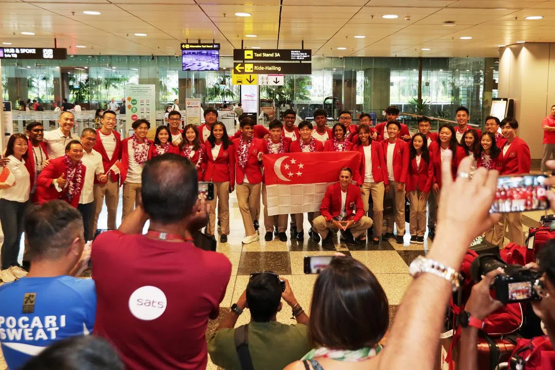 Singapore's athletics contingent returning from Cambodia on May 13. The contingent picked up 10 medals at the Cambodia SEA Games.