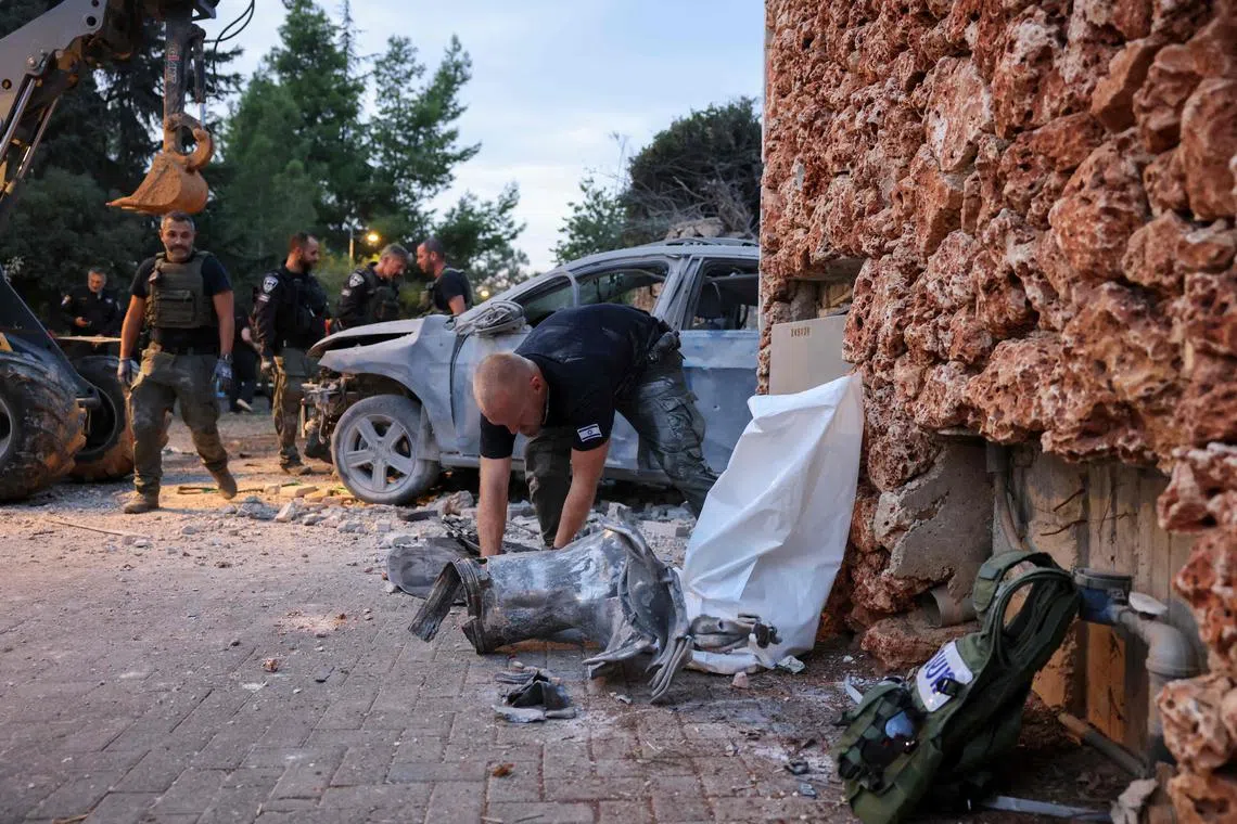 Israeli security forces inspecting damage from a rocket attack from Gaza in Har Adar, a well-to-do settlement north-west of Jerusalem, on Oct 9.