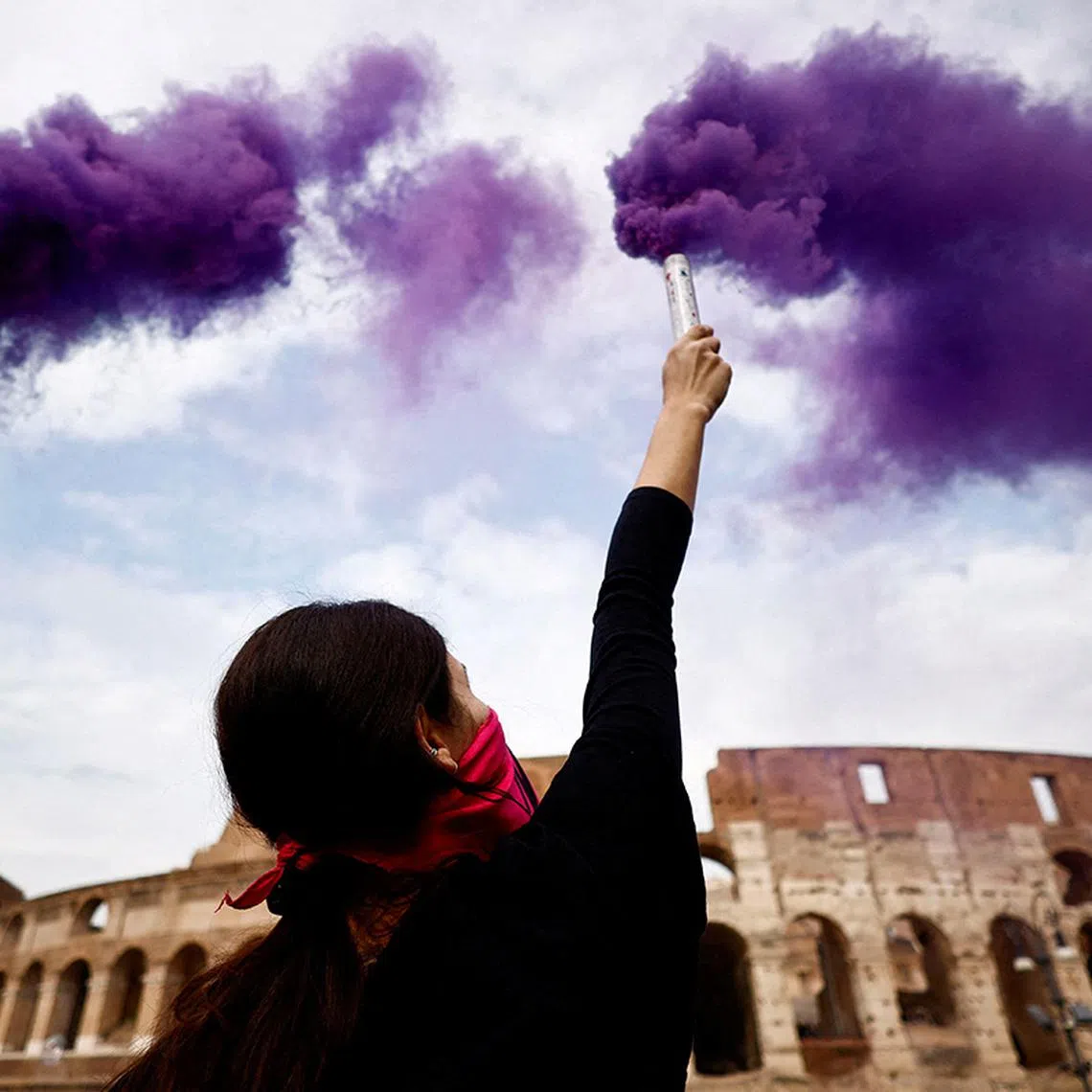 A person holds a smoke flare in front of the Colosseum during a protest to mark International Women's Day, in Rome, Italy, March 8, 2025. REUTERS/Yara Nardi TPX IMAGES OF THE DAY