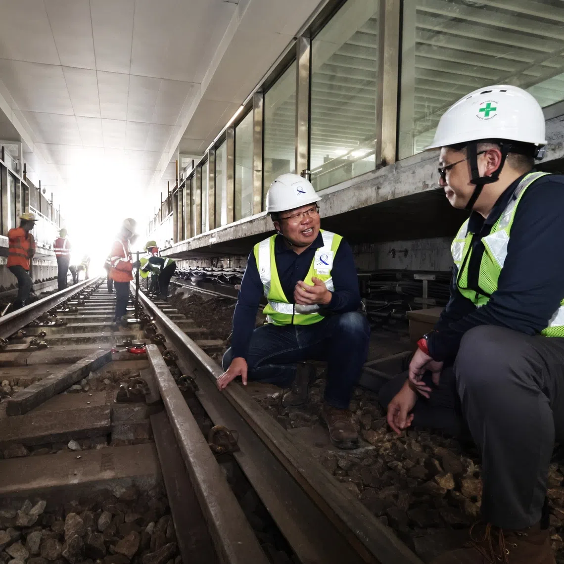 Mr Chia Choon Poh (second from right), LTA’s group director of rail (electrical and mechanical), with Mr William Low, LTA’s executive project engineer, checking out the progress of works to connect the East-West Line to the new East Coast Integrated Depot on Nov 30.