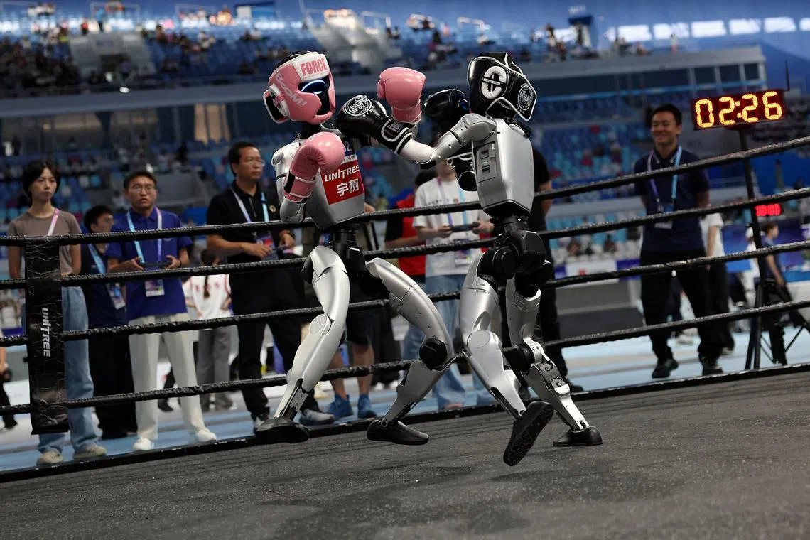 Unitree Robotics humanoid robots competing in a kickboxing match at the inaugural World Humanoid Robot Games, at the National Speed Skating Oval in Beijing, China, on Aug 15, 2025. 
