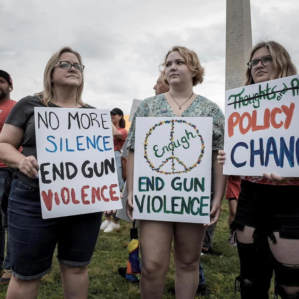 Demonstrators hold signs at "March for Our Lives", one of a series of nationwide protests against gun violence, in Washington, on June 11, 2022. 