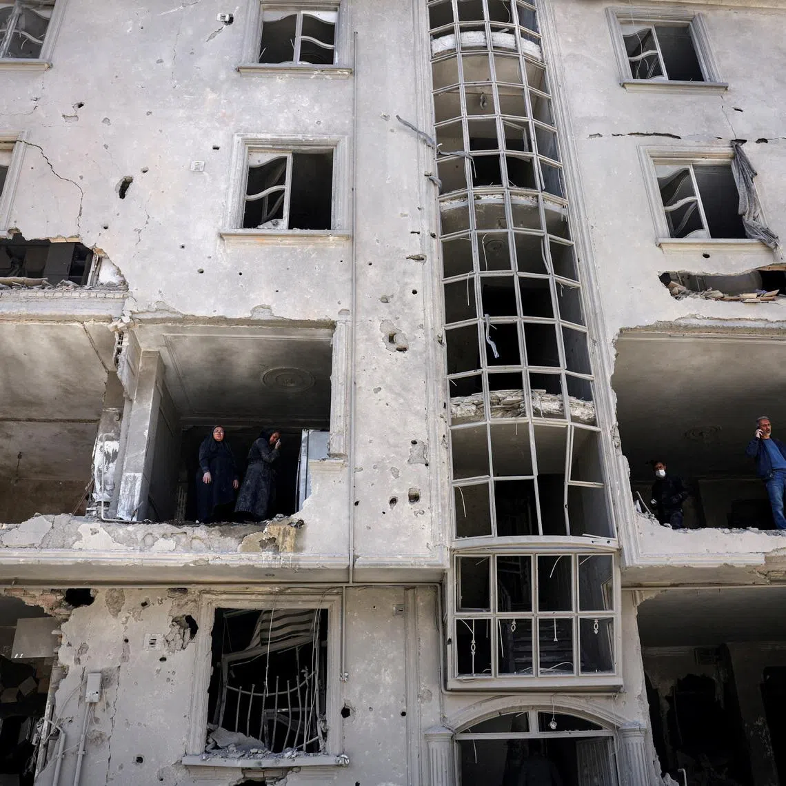 People inspect damage to a residential building after it was hit by a strike, amid the U.S.-Israeli conflict with Iran, in Tehran, Iran, March 30, 2026. Majid Asgaripour/WANA (West Asia News Agency) via REUTERS