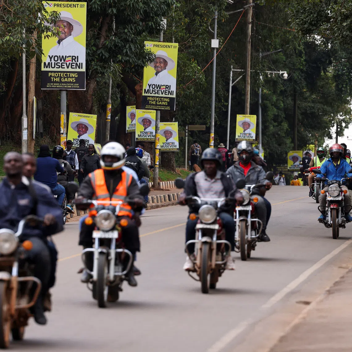 Motorcycle taxis ride past campaign posters of Uganda's President and leader of the ruling National Resistance Movement (NRM) party, Yoweri Museveni, ahead of the upcoming general election in Kampala, Uganda October 13, 2025. REUTERS/Miriam Watsemba