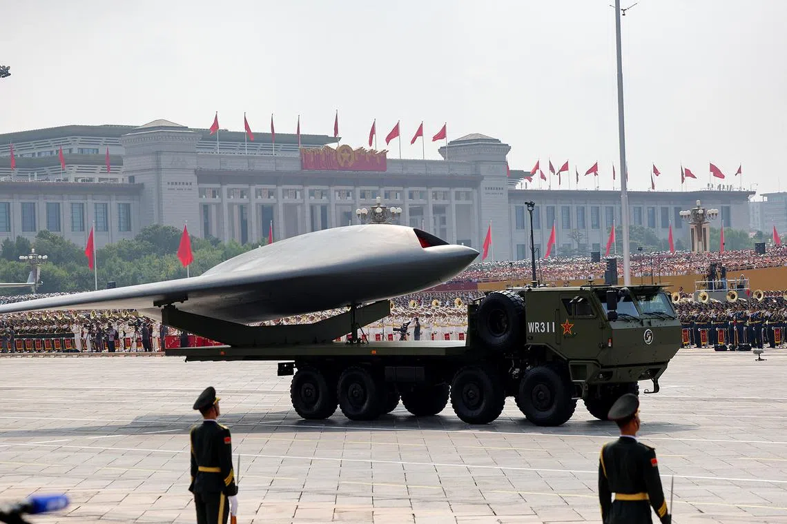 Members of the People's Liberation Army stands as an unmanned aerial vehicle is displayed during a military parade marking the 80th anniversary of victory over Japan and the end of World War II, in Beijing’s Tiananmen Square, China, on Sept 3, 2025. 