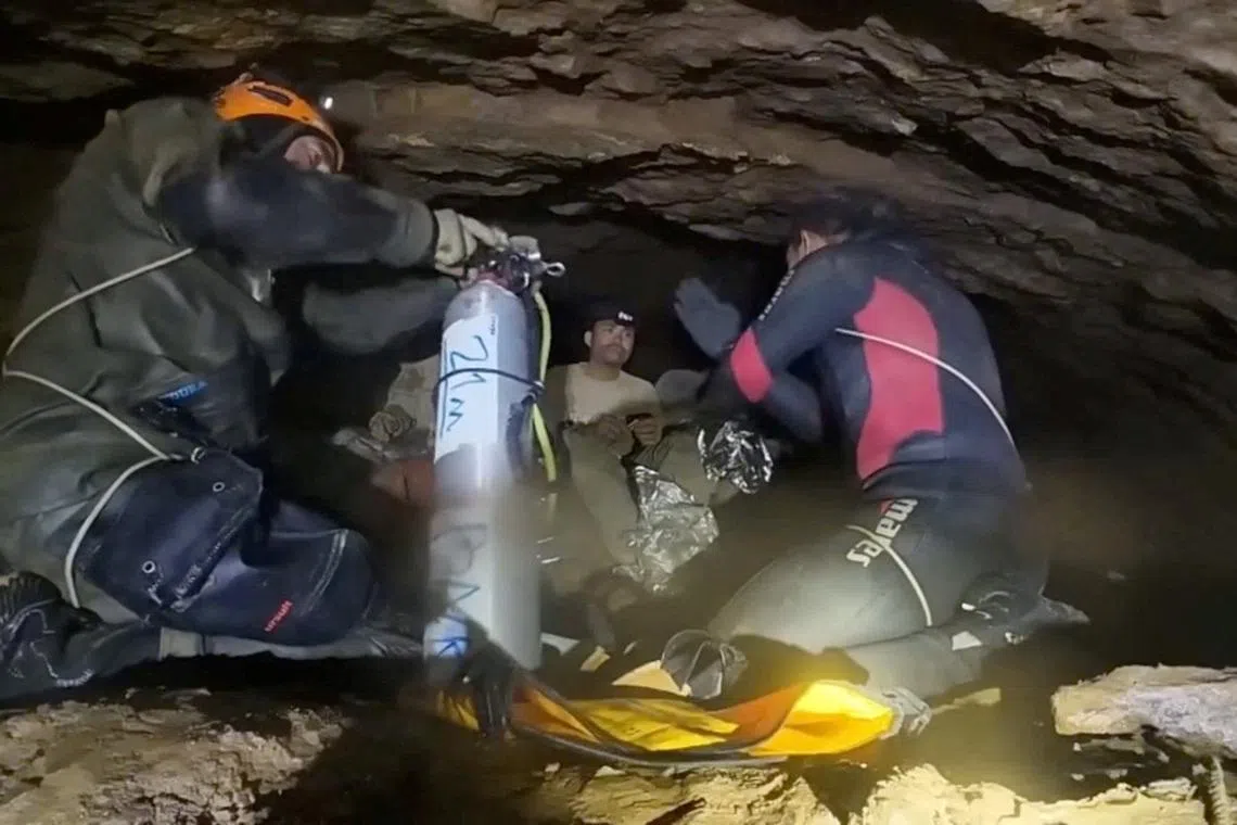 Rescue divers share the equipment usage guidelines with people trapped inside a cave during their rescue mission in Xaisomboun Province, Laos, in this screengrab obtained from a social media video released on May 30, 2026. Norrased Palasing/via REUTERS