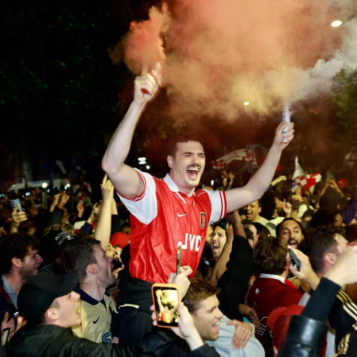 Arsenal fans outside the Emirates Stadium celebrate their team wining the English Premier League.