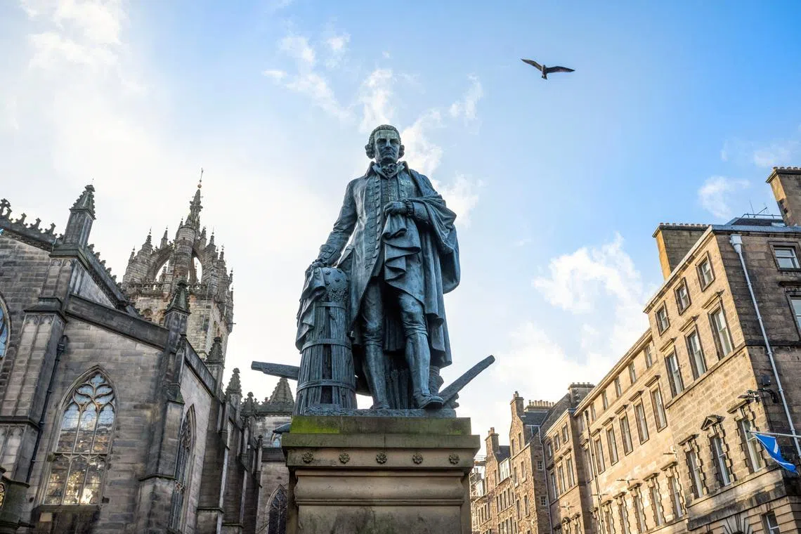 The bronze statue of Adam Smith, renowned economist and philosopher, located on the Royal Mile, positioned just outside St Giles' Cathedral in Edinburgh, Scotland, Britain February 20, 2026. REUTERS/Lesley Martin