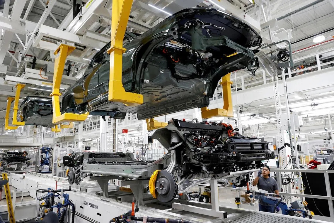 An employee works on an assembly line at an electric vehicle factory in Normal, Illinois.