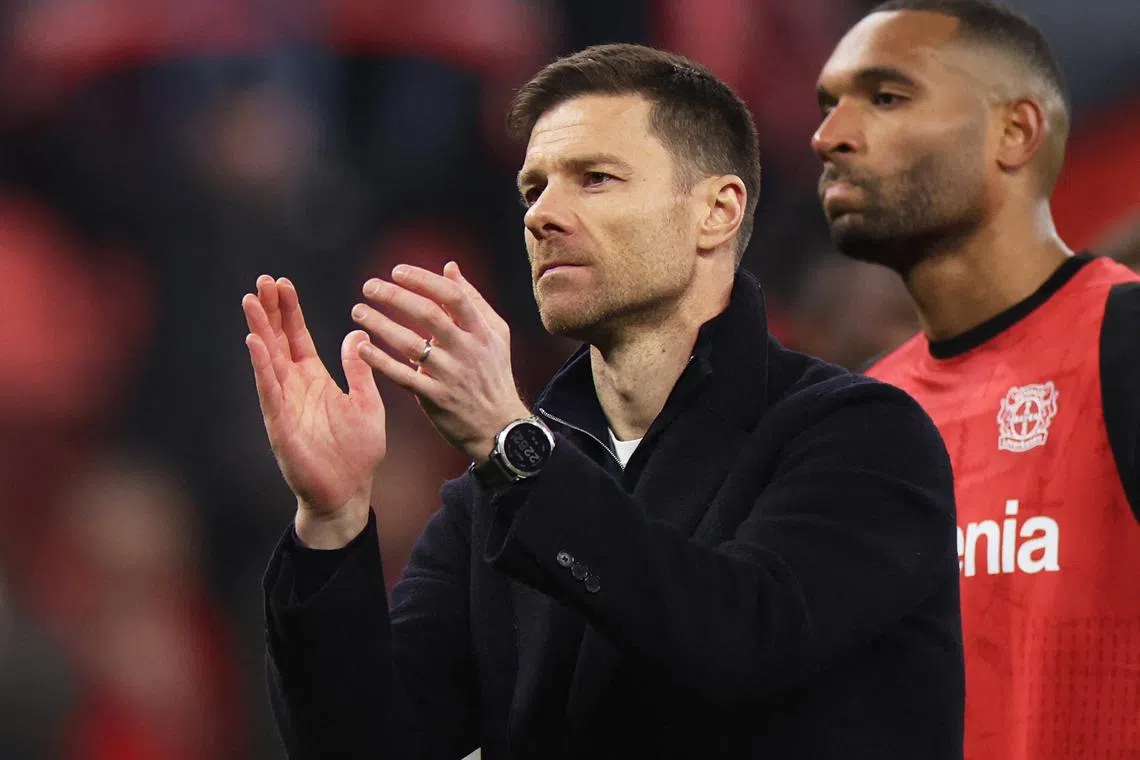 FILE PHOTO: Soccer Football - Champions League - Round of 16 - Second Leg - Bayer Leverkusen v Bayern Munich - BayArena, Leverkusen, Germany - March 11, 2025 Bayer Leverkusen coach Xabi Alonso applauds fans after losing the match REUTERS/Wolfgang Rattay/File Photo