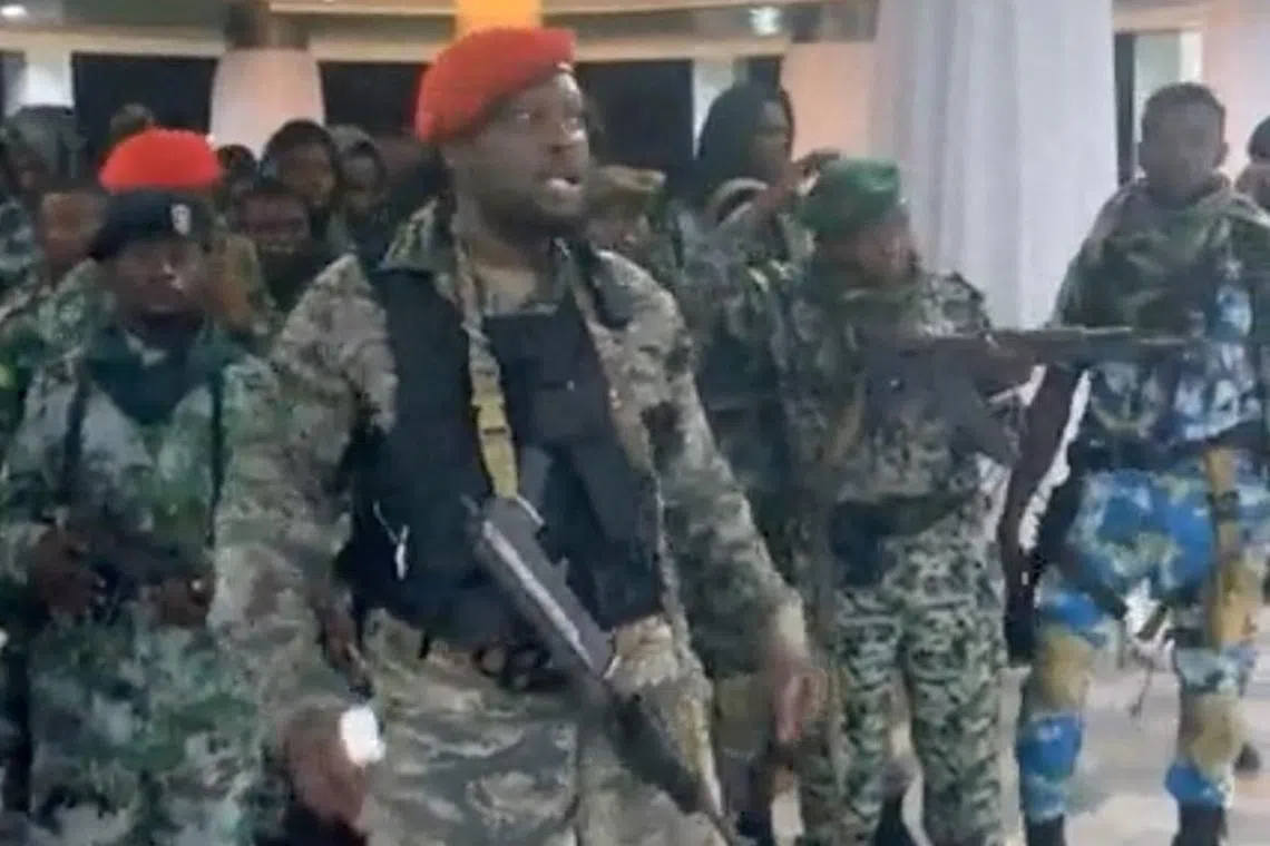 A man in military fatigues speaks as others stand next to him inside the Palace of the Nation during an attempted coup in Kinshasa, Democratic Republic of Congo, May 19, 2024 in this screen grab from a social media video. Christian Malanga/Handout via REUTERS