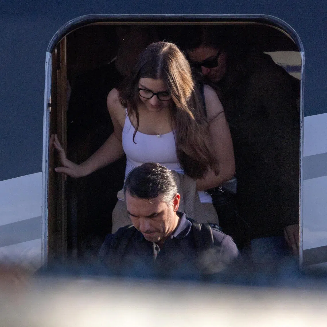 Brazilian Senator Flavio Bolsonaro disembarking from a plane with his family after arriving in the US state of Florida on Oct 28.