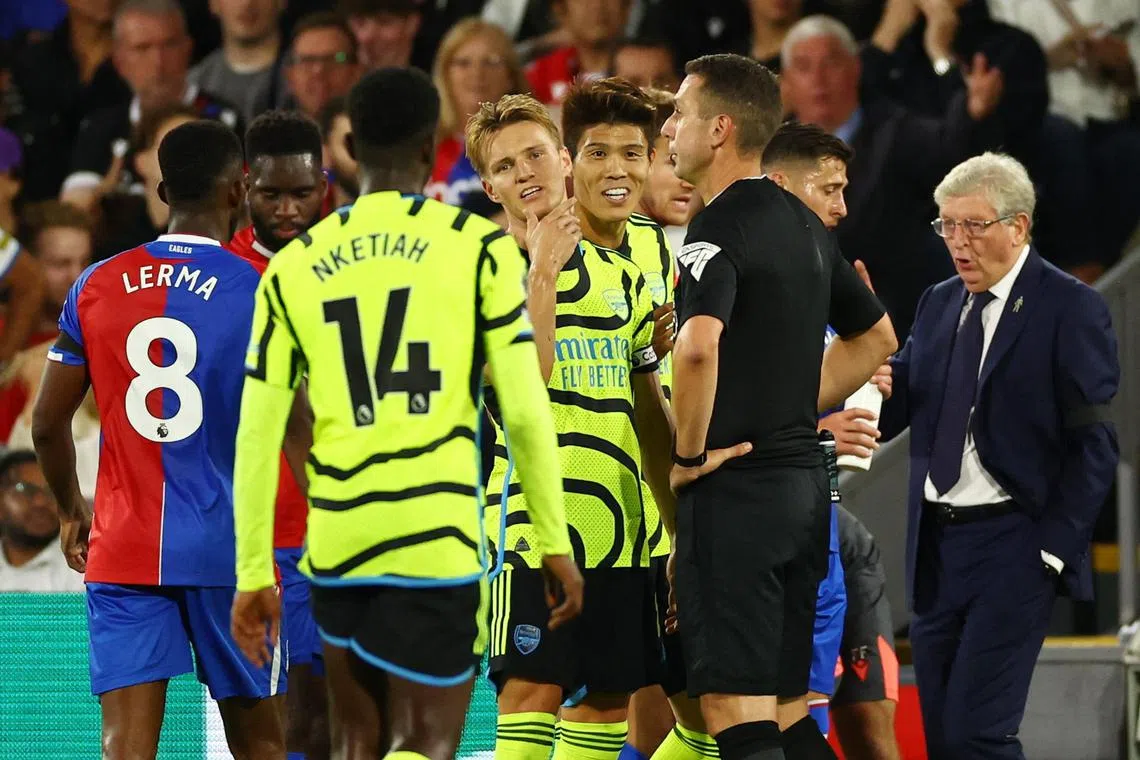 Arsenal's Takehiro Tomiyasu (centre) reacts after being sent off by referee David Coote, on Aug 21, 2023.