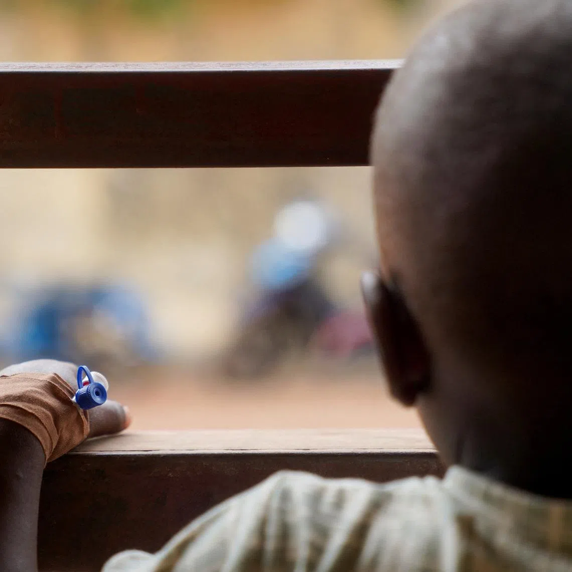 FILE PHOTO: A child living with HIV, wearing an intravenous (IV) cannula in the hand, looks on, at the Federal Medical Centre in Makurdi, Benue State, Nigeria, February 11, 2026. REUTERS/Marvellous Durowaiye/File Photo