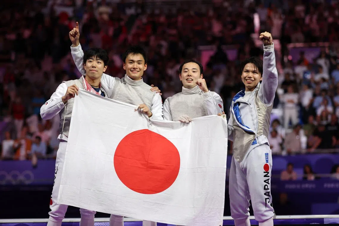 Paris 2024 Olympics - Fencing - Men's Foil Team Gold Medal Match - Grand Palais, Paris, France - August 04, 2024. Kyosuke Matsuyama of Japan, Kazuki Iimura of Japan, Takahiro Shikine of Japan and Yudai Nagano of Japan celebrate after winning the Gold medal. REUTERS/Maye-E Wong