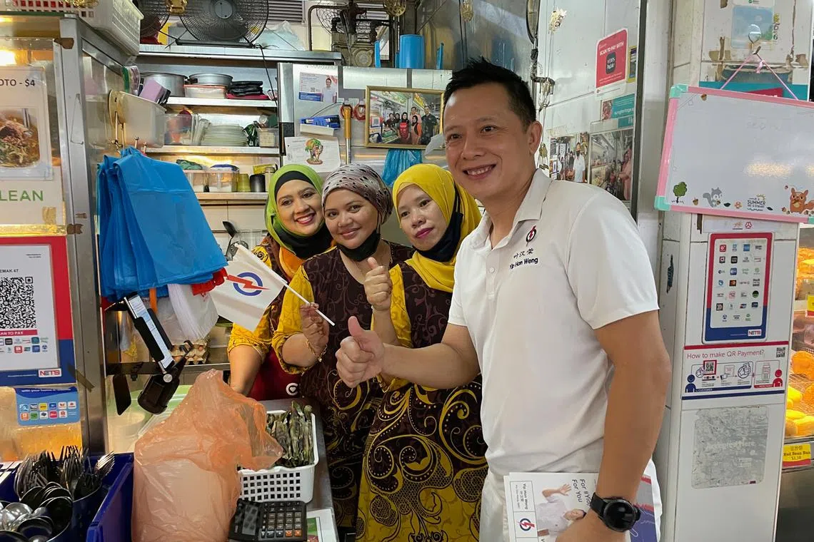 The PAP's Yio Chu Kang candidate Yip Hon Weng with hawkers during a walkabout at the market at Blk 628 Ang Mo Kio on April 29.