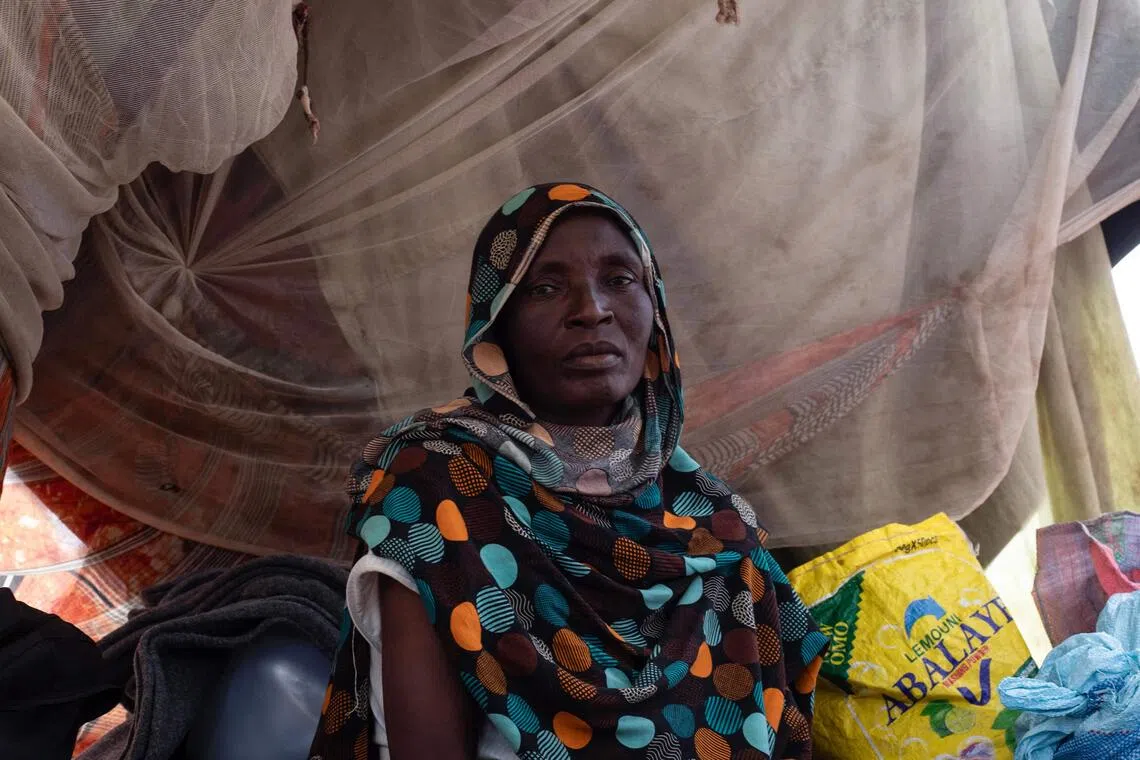 A Sudanese woman who fled El-Fasher after the city fell to rebel forces sits inside a makeshift shelter in Sudan’s western Darfur region.
