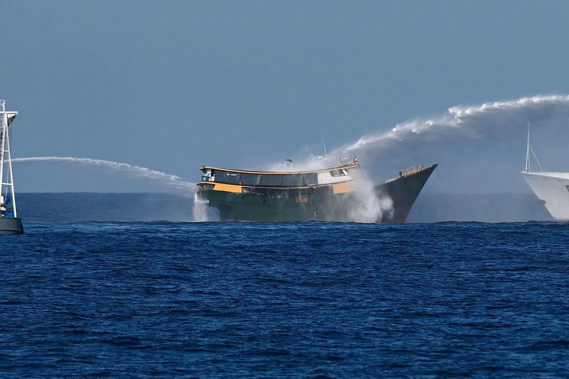 Chinese coast guard vessels train water cannons on a Philippine supply boat near the Second Thomas Shoal on March 5, 2024.