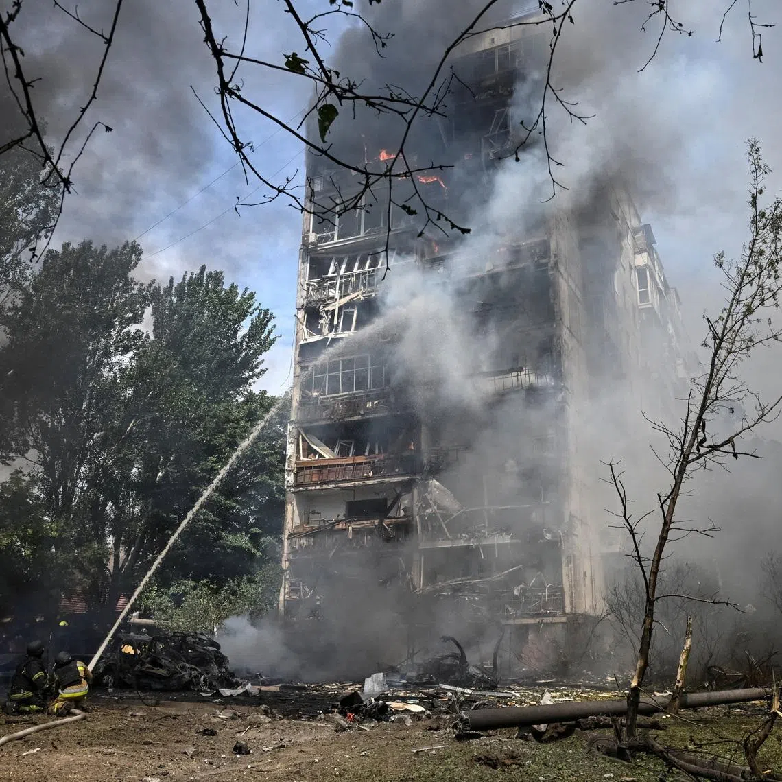 Rescuers work at the site of an apartment building hit by a Russian air strike, amid Russia's attack on Ukraine, in Zaporizhzhia, Ukraine, July 21, 2026. REUTERS/Stringer