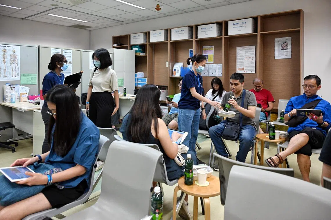 Singapore Population Health Studies (SPHS) staff with participants undergoing health screening at the Saw Swee Hock School of Public Health on Nov 9. 