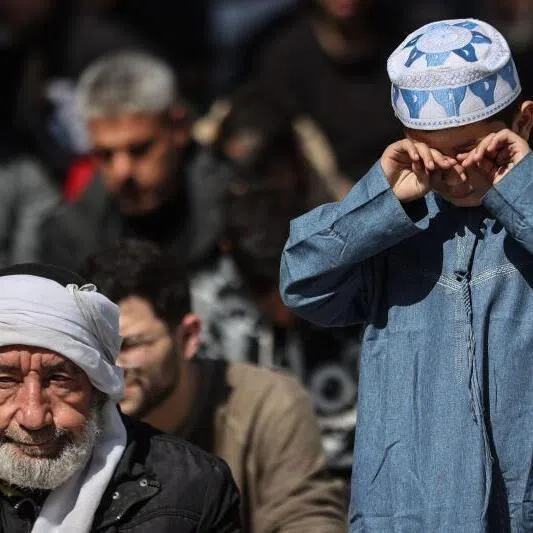 A Palestinian Muslim child rubs his eyes as he gathers with worshippers during the first Friday noon prayers of the holy month of Ramadan in Gaza City, on Feb 20, 2026.