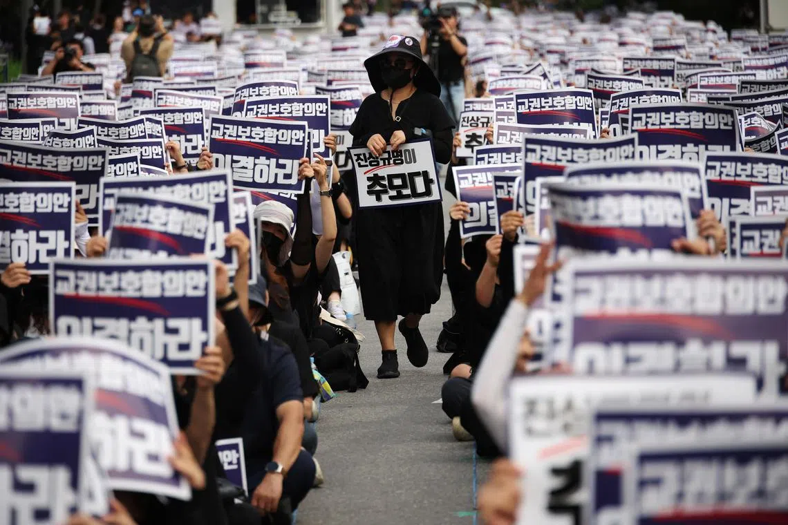 South Korean teachers take part in a protest to demand better protection of their rights and to mourn a young teacher found dead in July in an apparent suicide.