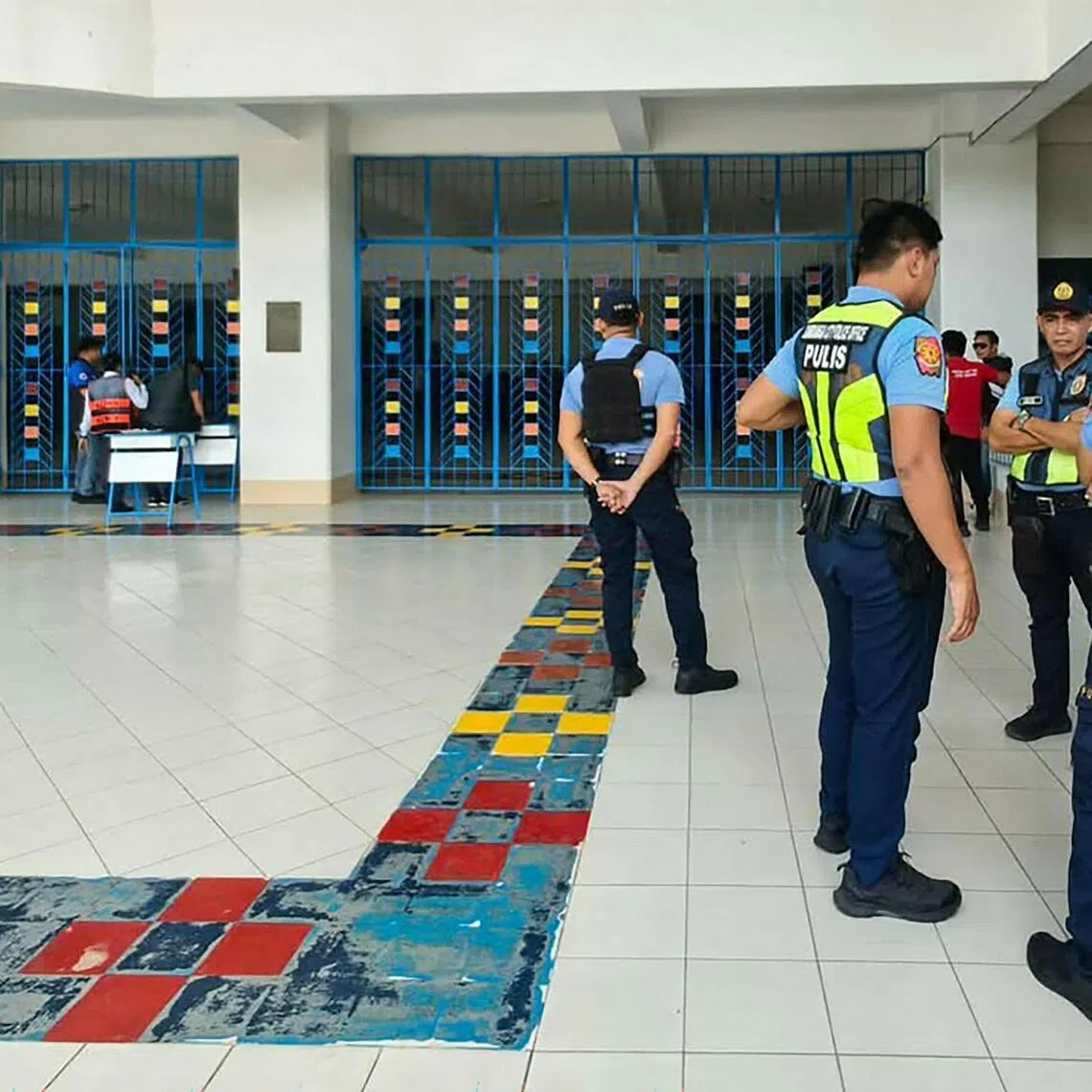 Philippine police gather at a school following a shooting in Zamboanga, the Philippines, on Aug 18. A student was shot dead before the alleged killer took his own life.