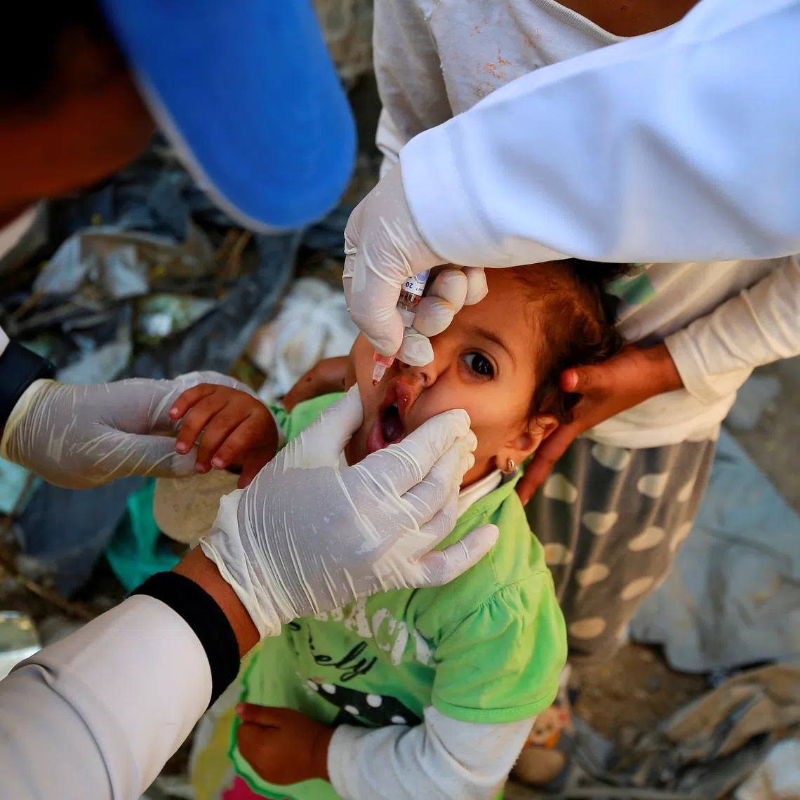 A girl receives a polio vaccine during a three-day immunization campaign in Sanaa, Yemen November 29, 2020. REUTERS/Nusaibah Almuaalemi