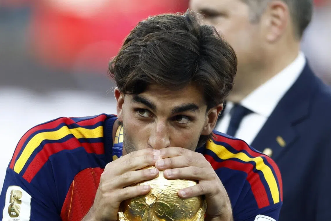 Ferran Torres of Spain kisses the World Cup trophy after the final against Argentina.