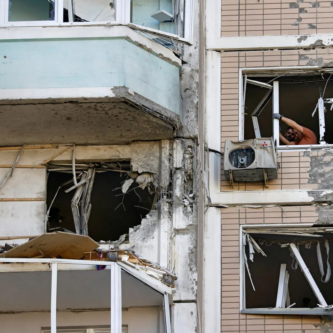 Residents clear broken windows in a damaged apartment building following a Ukrainian drone attack in the course of Russia-Ukraine conflict in Krasnogorsk, in the Moscow region, Russia May 17, 2026. REUTERS/Stringer