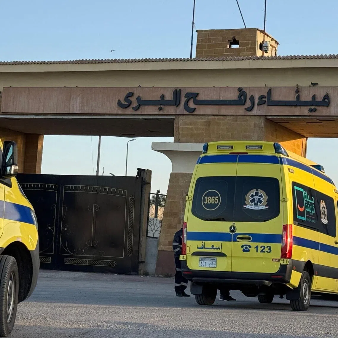 Ambulances wait in line at the Egyptian side of the Rafah border crossing with the Palestinian Gaza Strip.  