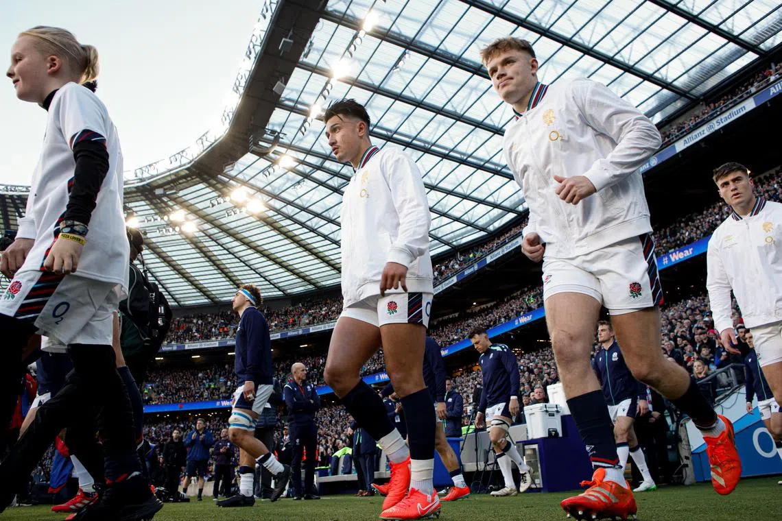 Marcus Smith of England (centre) walks on to the pitch for the Six Nations rugby match against Scotland.