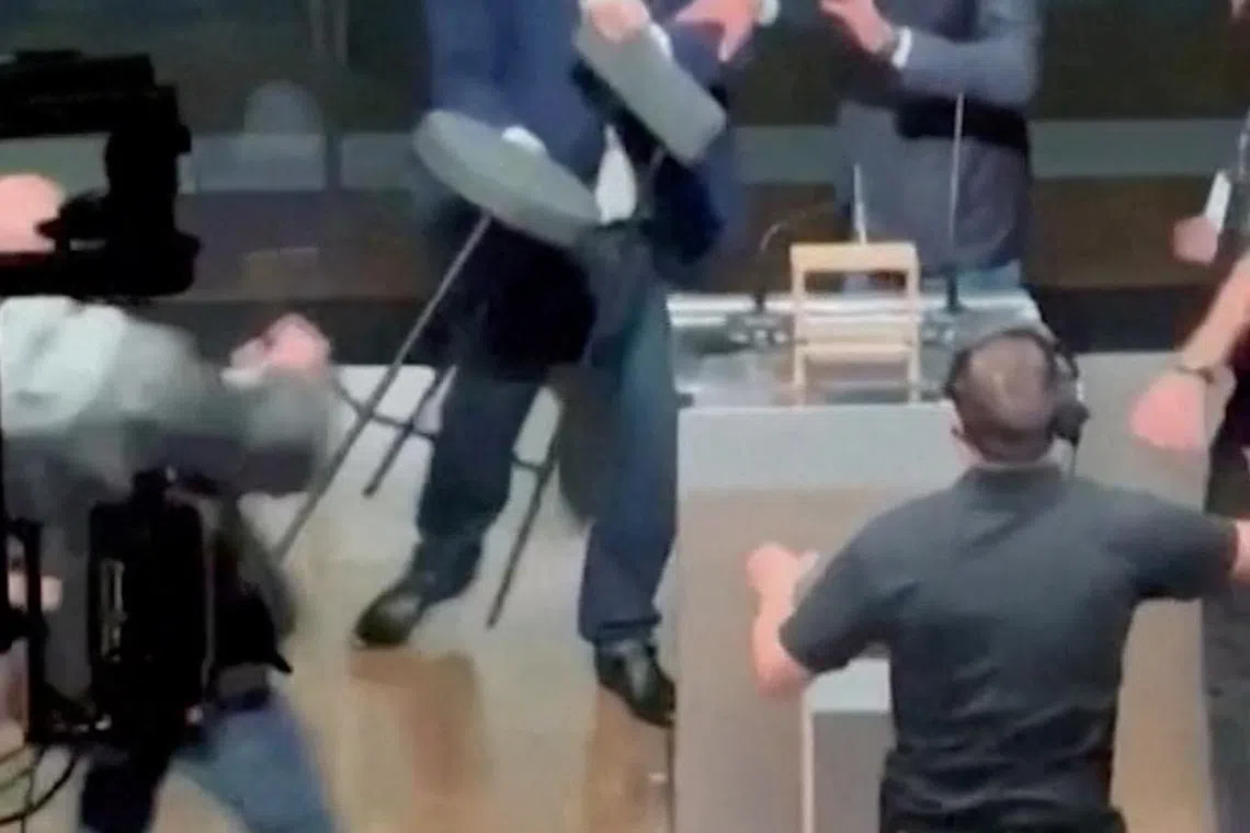 Candidate for Sao Paulo Mayor Jose Luiz Datena throws a chair at his opponent Pablo Marcal (not seen) during a televised debate, in Sao Paulo, Brazil September 15, 2024. SITE TV POP/Reuters TV via REUTERS