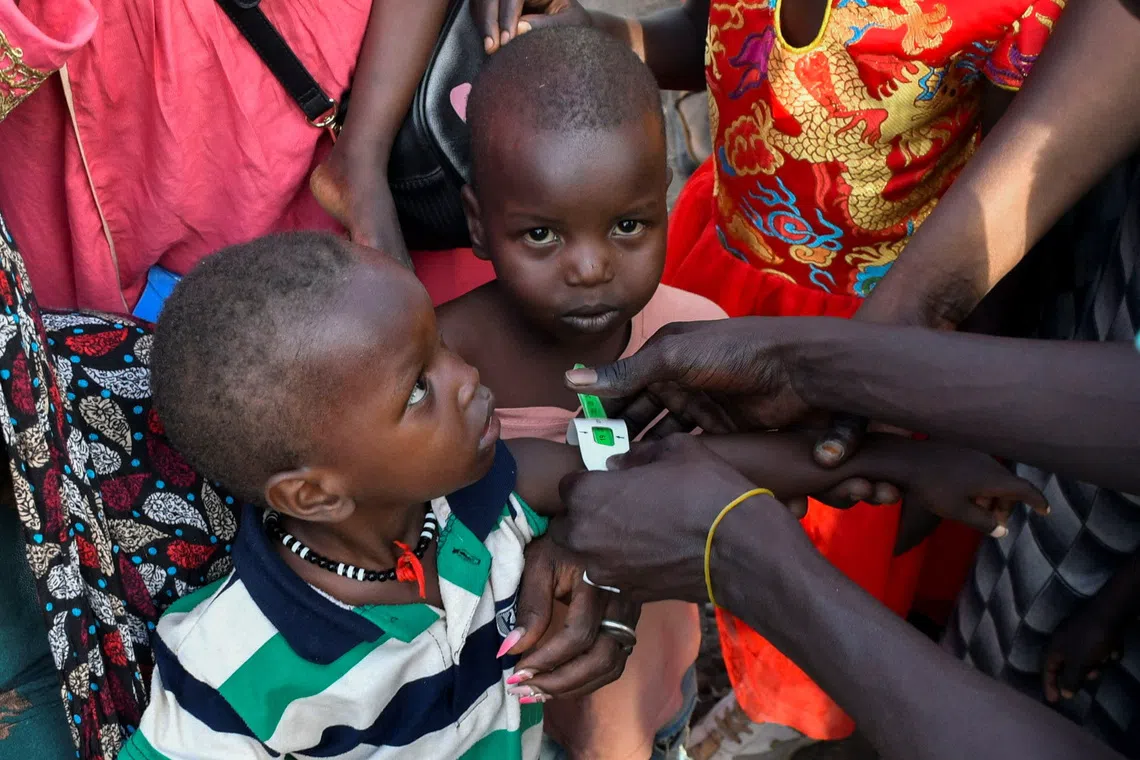 FILE PHOTO: Children are examined for malnutrition, as civilians who fled the war-torn Sudan following the outbreak of fighting between the Sudanese army and the paramilitary Rapid Support Forces (RSF) gather to register at the United Nations High Commissioner for Refugees (UNHCR) after crossing at the Joda South border point, in Renk County, Upper Nile state, South Sudan, April 30, 2023. REUTERS/Jok Solomun/File Photo