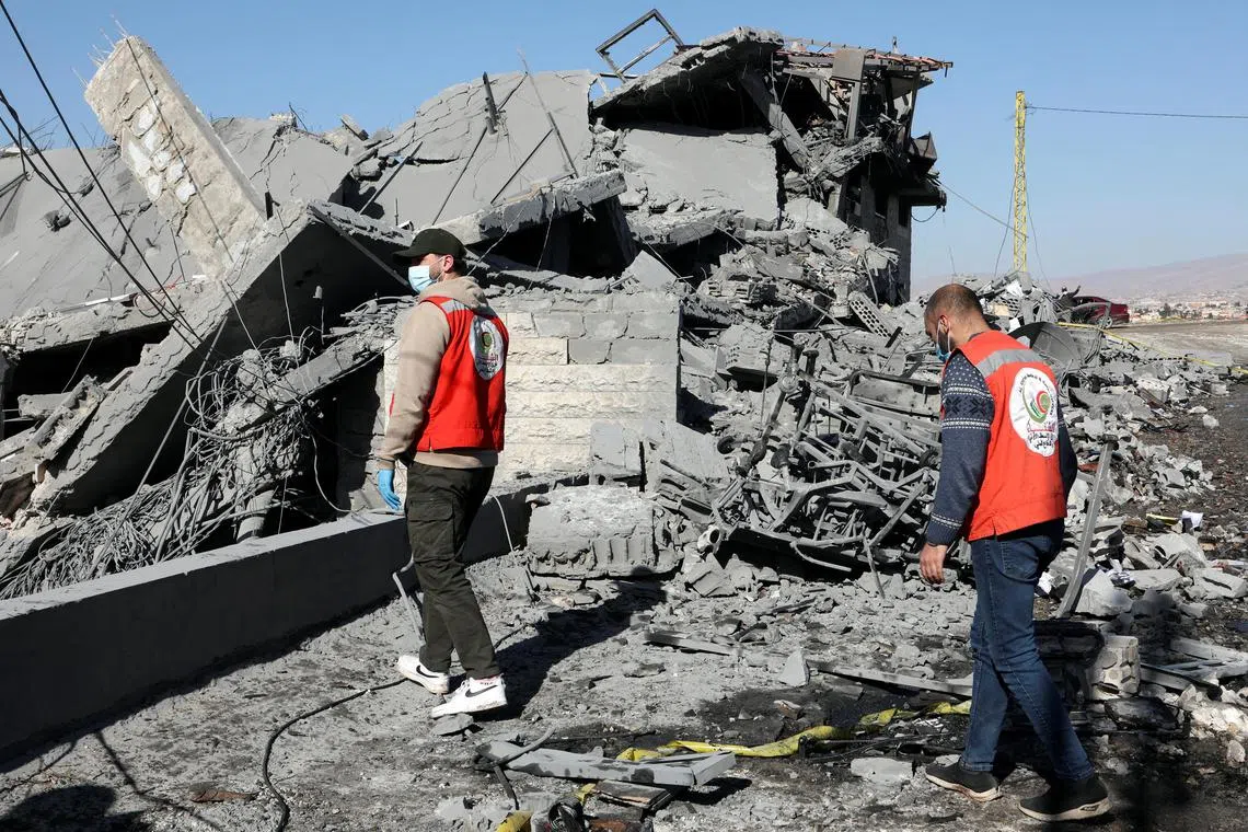Civil defence members walk on the rubble of a damaged site that was hit by a strike, after Israel launched four strikes on eastern Lebanon's Baalbek on March 11.
