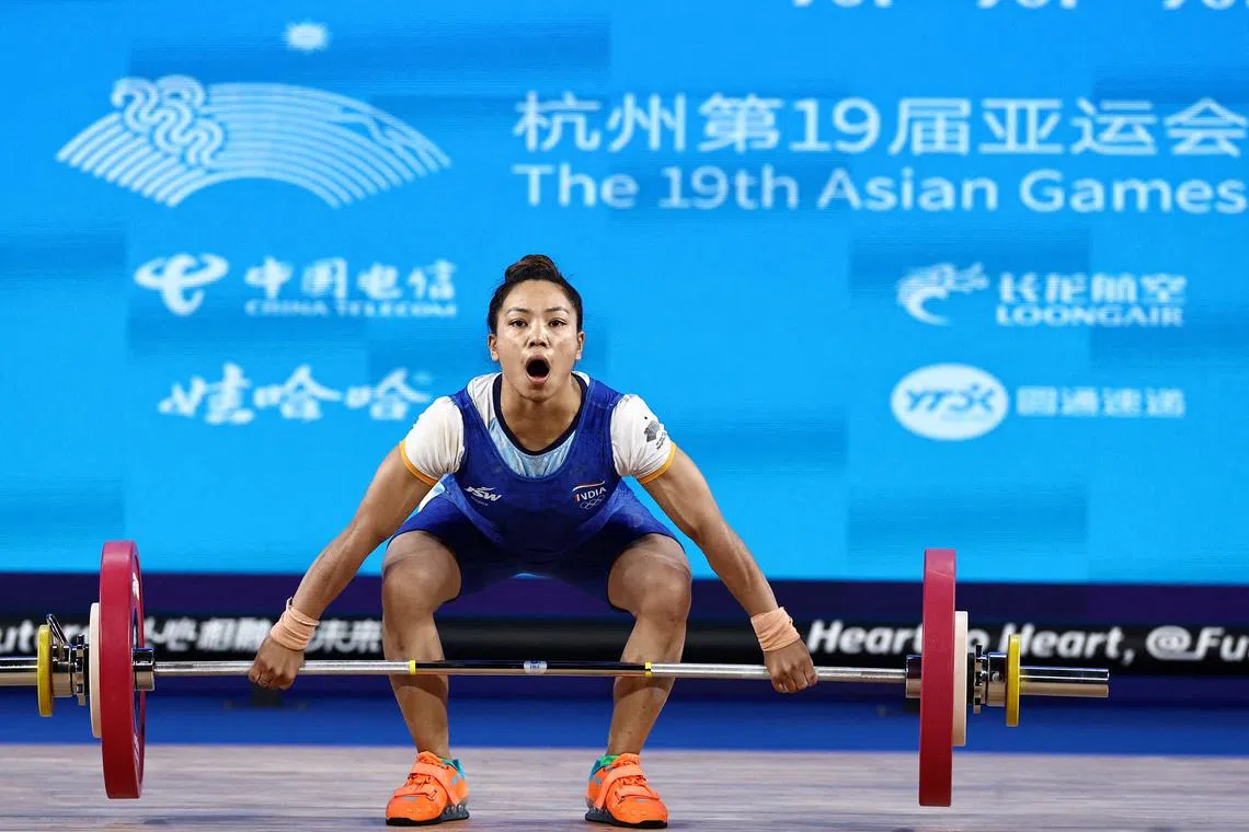 FILE PHOTO: Asian Games - Hangzhou 2022 - Weightlifting - Xiaoshan Sports Centre Gymnasium, Hangzhou, China - September 30, 2023 India's Mirabai Chanu Saikhom in action REUTERS/Ann Wang